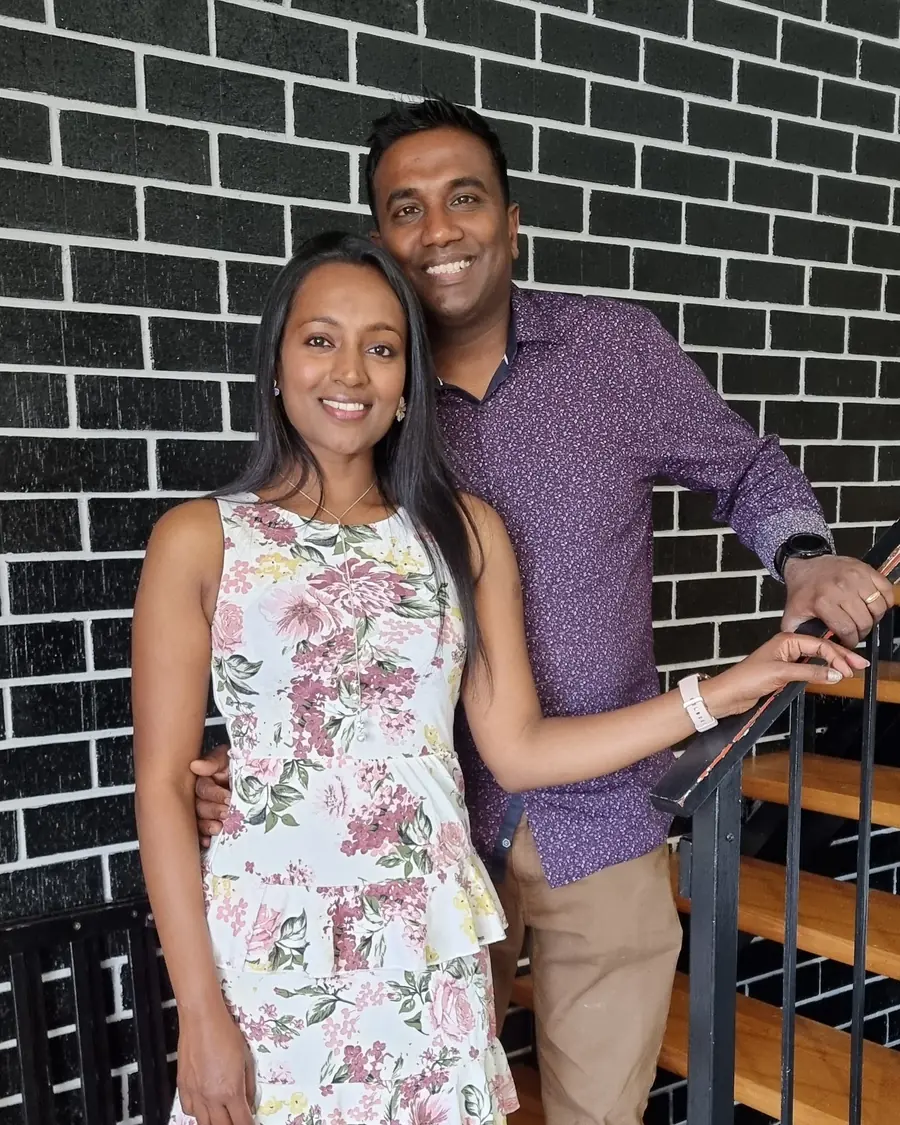 Sarah Jeff with her husband, standing together on a staircase